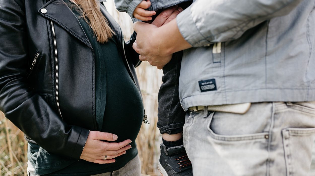 Een baby in de buik en een jongetje op vaders arm.